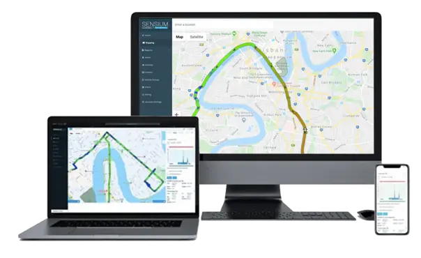 An array of devices including a laptop, a desktop monitor, and a smartphone displaying a navigation map with route information from Sensium's mapping software.